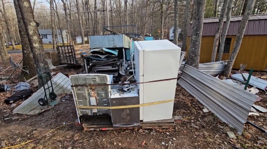 Old appliances staged in a garage before pickup in Menifee, CA