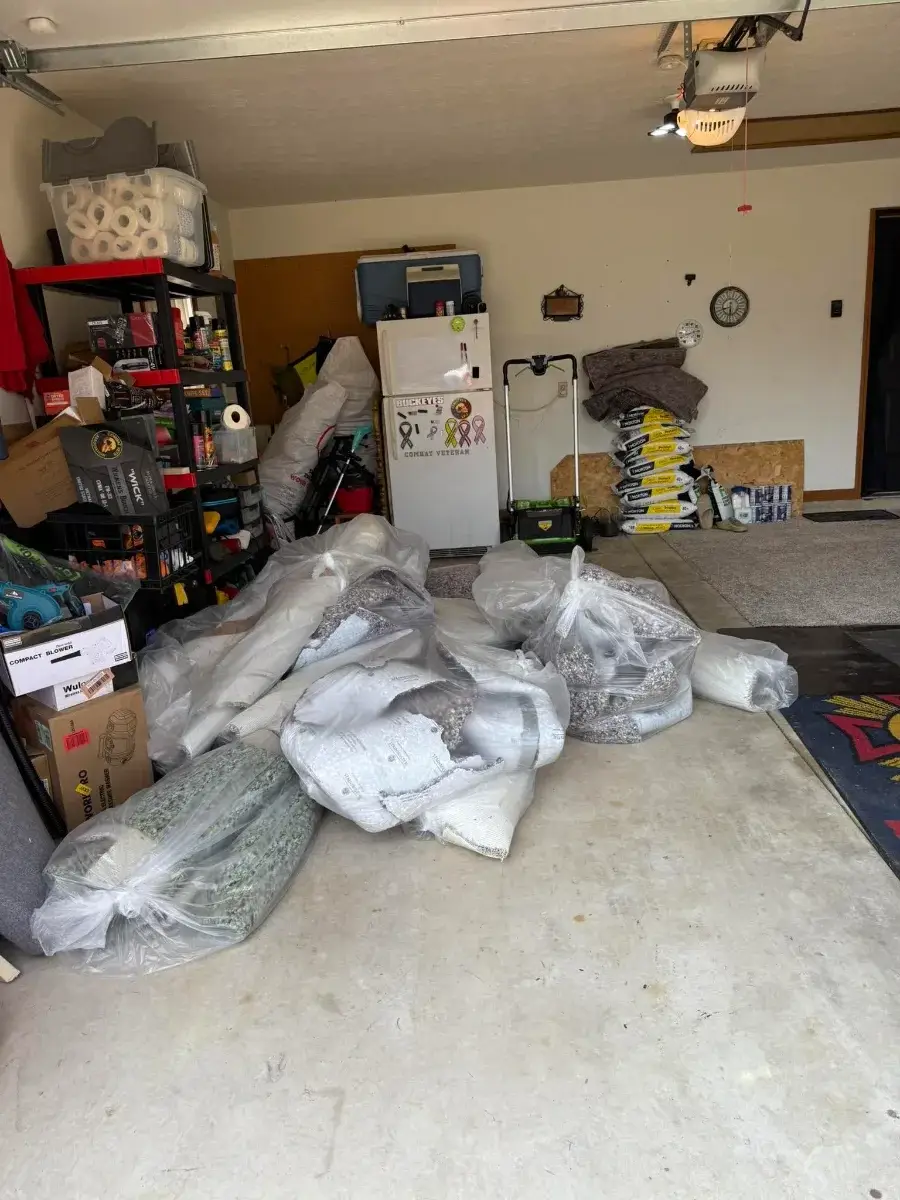 Before junk removal — cluttered Sun City garage in Menifee