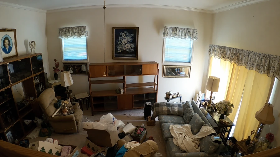 Living room cluttered with old furniture before removal in Menifee, CA
