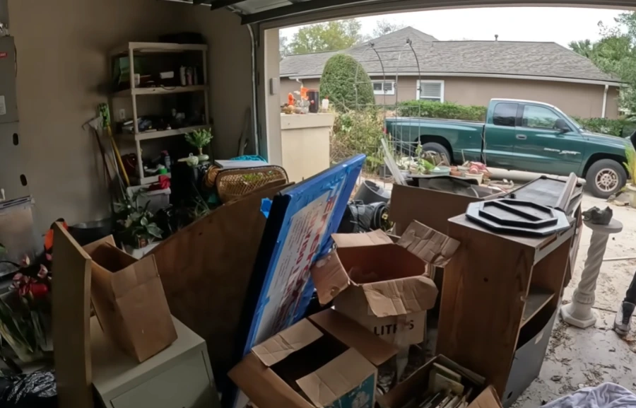 A heavily cluttered two-car garage before being sorted and cleared