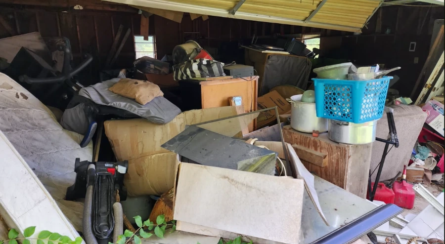 Garage packed floor to ceiling before a Menifee garage cleanout